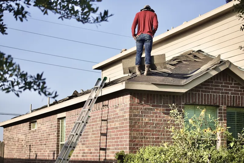 Professional roofer working on a residential roof in Ambler